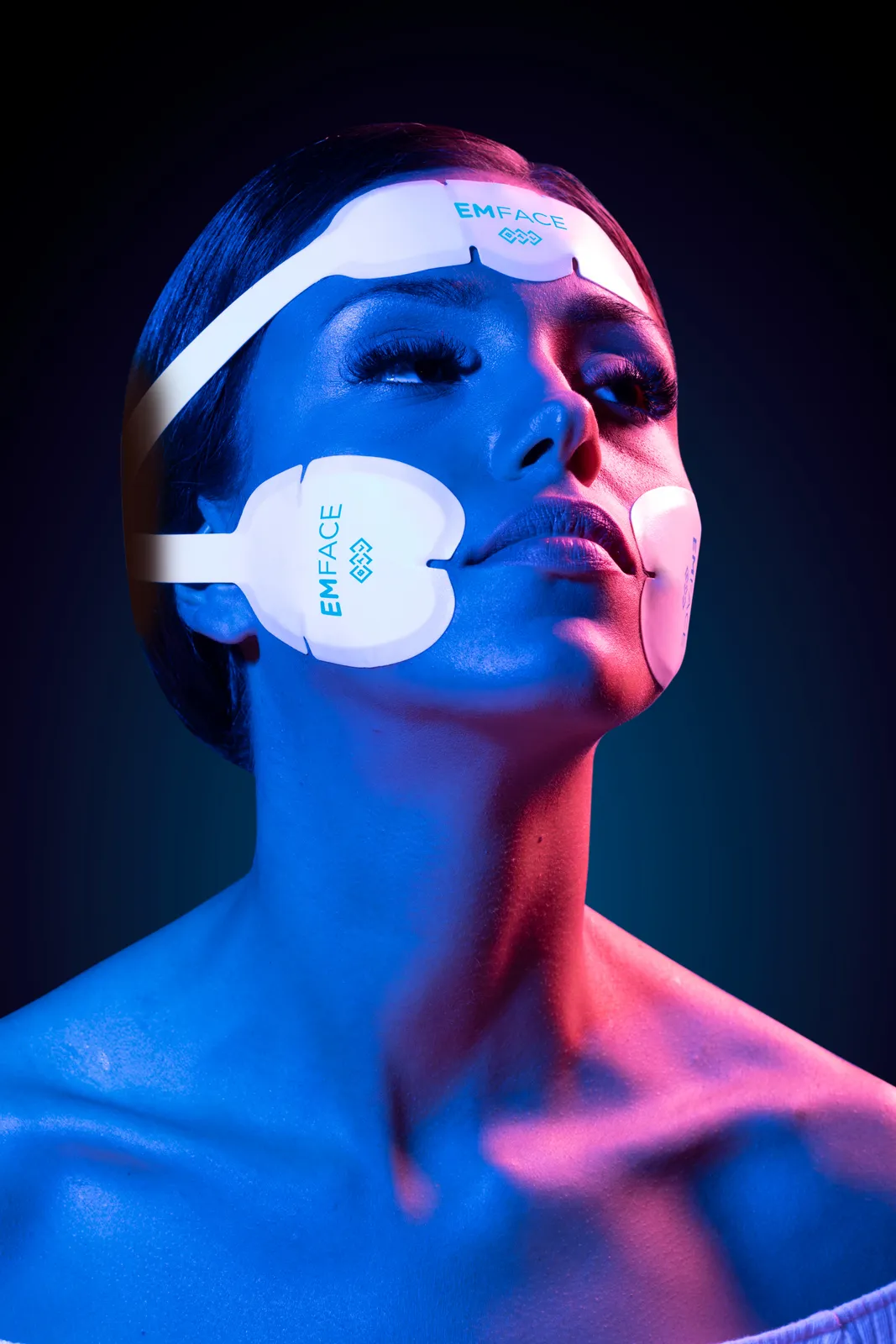 Model wearing EMFACE facial and jawline applicators